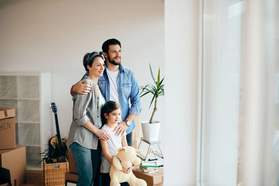 Family looking through a home window